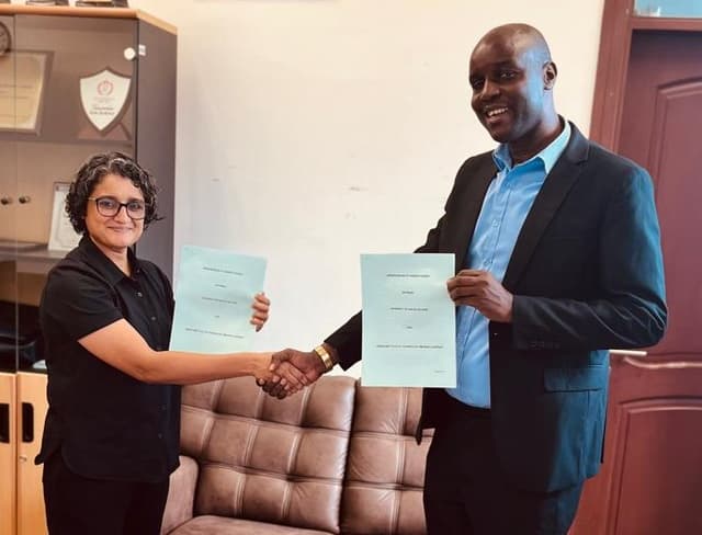 Image of signing of MOU with UDSM